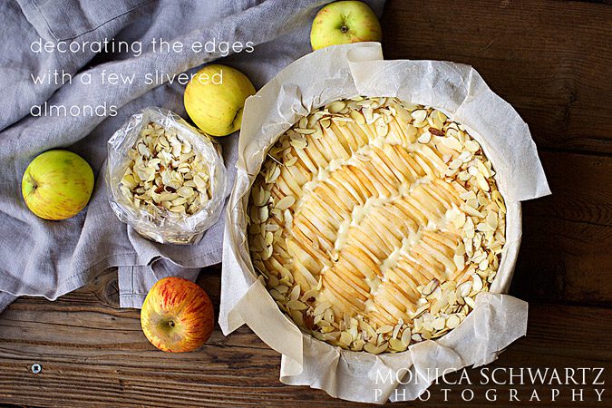 Arranging-slivered-almonds-around-the-edges-of-the-unbaked-apple-cake
