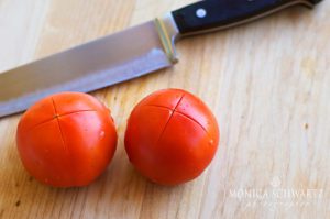 Cross-cutting-tomatoes-to-make-pasta-salad
