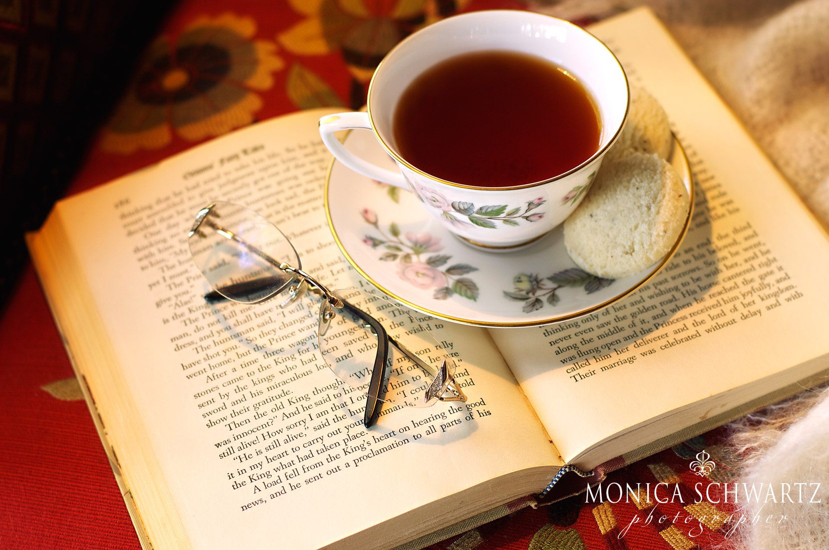 The-comfort-of-reading-a-good-book-curled-up-on-an-armchair-under-a-blanket-and-with-a-cup-of-tea