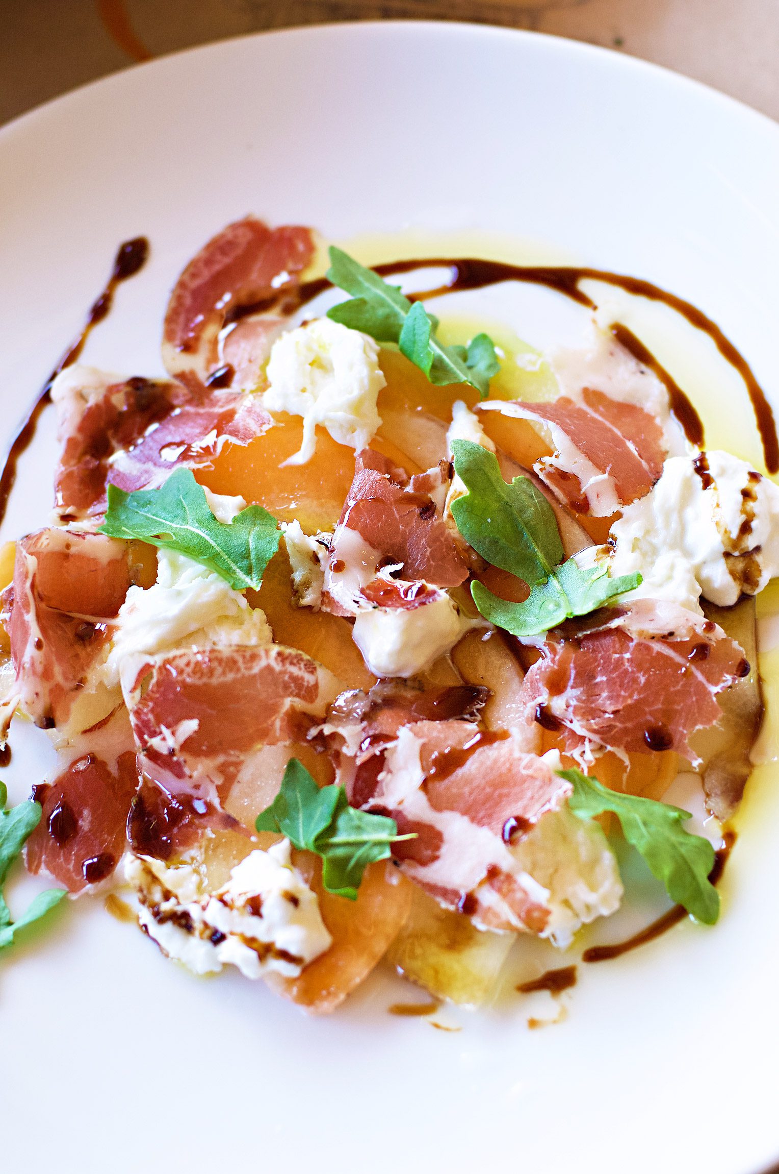 Burrata-Coppa-and-Cantaloupe-Salad-at-The-Girl-and-The-Fig-restaurant-in-Sonoma-California-photography-by-Monica-Schwartz