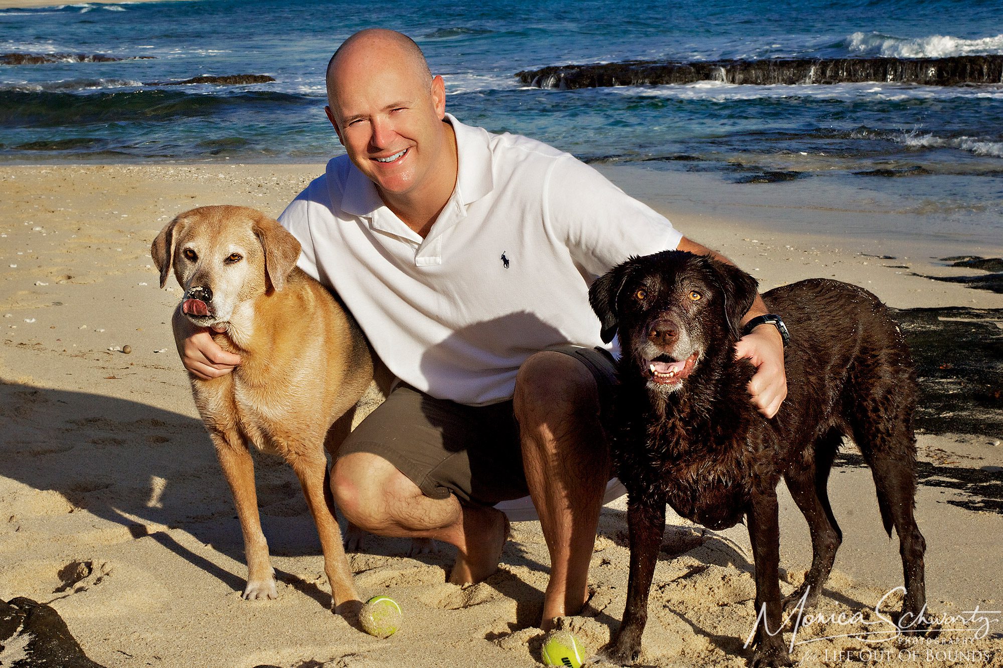 Maggie-and-Molly-girl-dogs-with-their-human-daddy-at-North-Beach-in-Kaneohe-Oahu-Hawaii