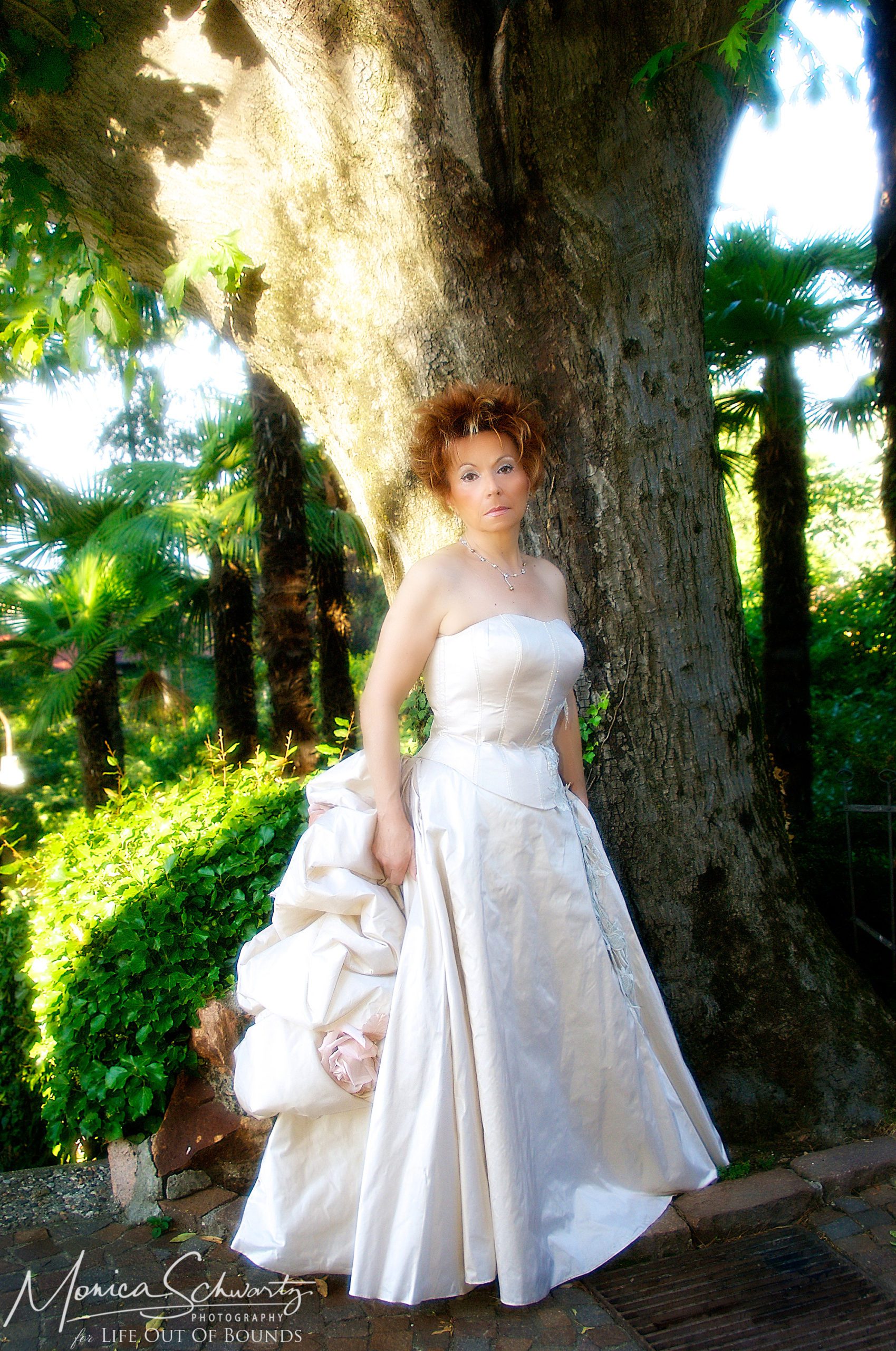 Portrait-of-an-Italian-woman-wearing-a-rose-ball-gown-in-a-garden-setting