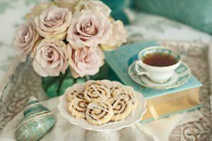 The-comfort-of-tea-cookies-roses-and-a-good-book-on-a-tray-in-bed