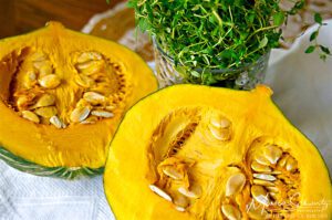 Kabocha squash cut in half with a glass of fresh thyme to make Shrimp and Thyme to make Gyoza (potstickers) with Shrimp, Kabocha and Thyme, recipe