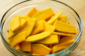 Peeled, seeded and sliced Kabocha squash to make Purple Sweet Potato, Kabocha and Onion Millefeuille with Taleggio and Lehua Blossom Honey