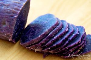 Sliced Okinawan purple sweet potato to make Purple Sweet Potato, Kabocha and Onion Millefeuille with Taleggio and Lehua Blossom Honey