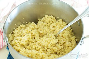 Fluffing cooked quinoa as part of a recipe with mushrooms and kabocha