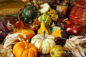 Warm autumn pumpkin composition with candle and harvest fruits