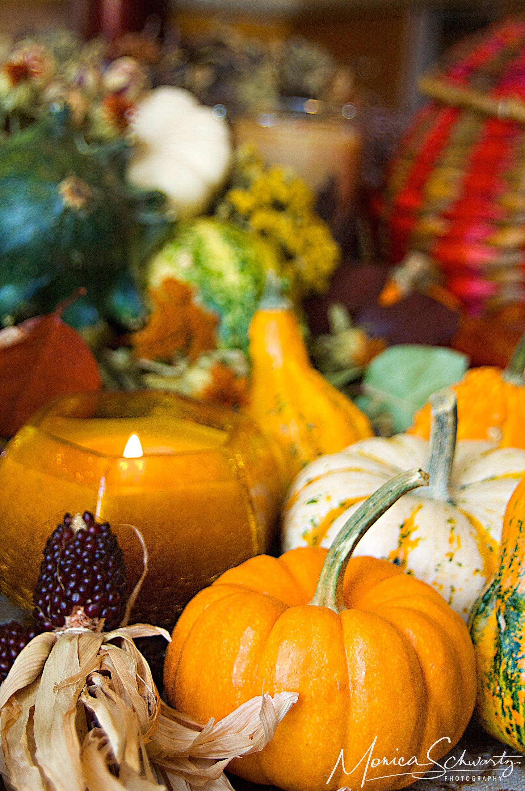 Warm autumn pumpkin composition with candle and harvest fruits